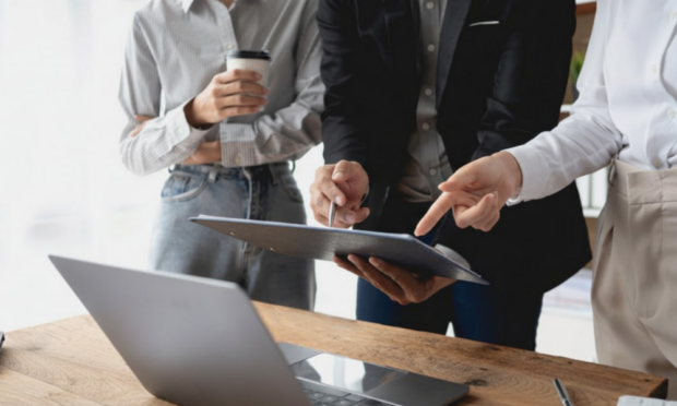 Group of business professionals discussing ERP and financial management software investment during a strategic planning meeting.